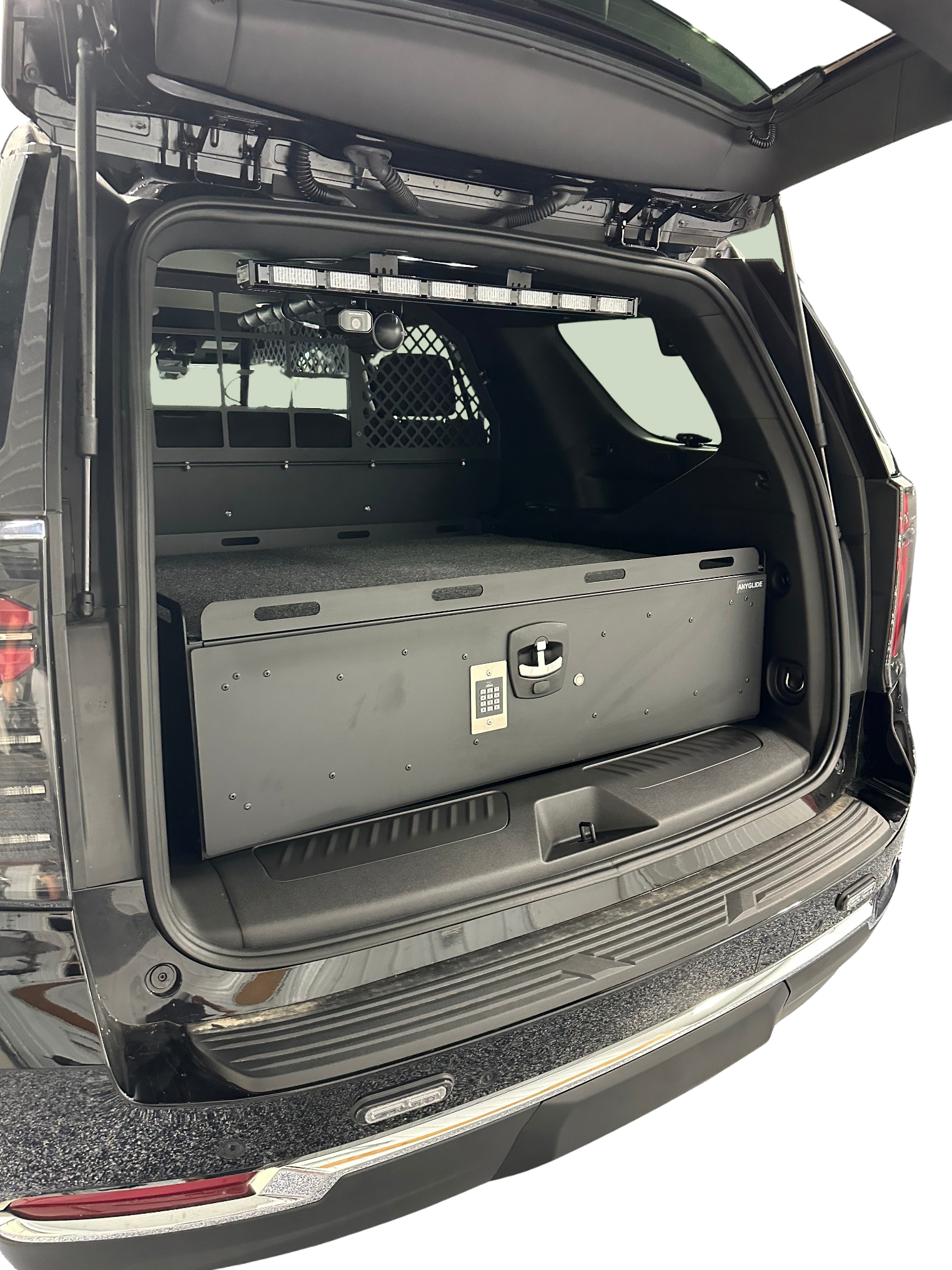 Open trunk of a black SUV with a toolbox inside