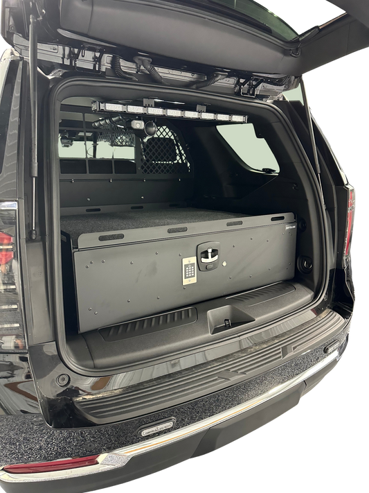 Open trunk of a black SUV with a toolbox inside